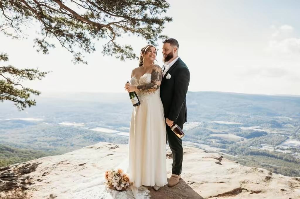 Bride and groom on a mountain overlook, custom mobile spray tan